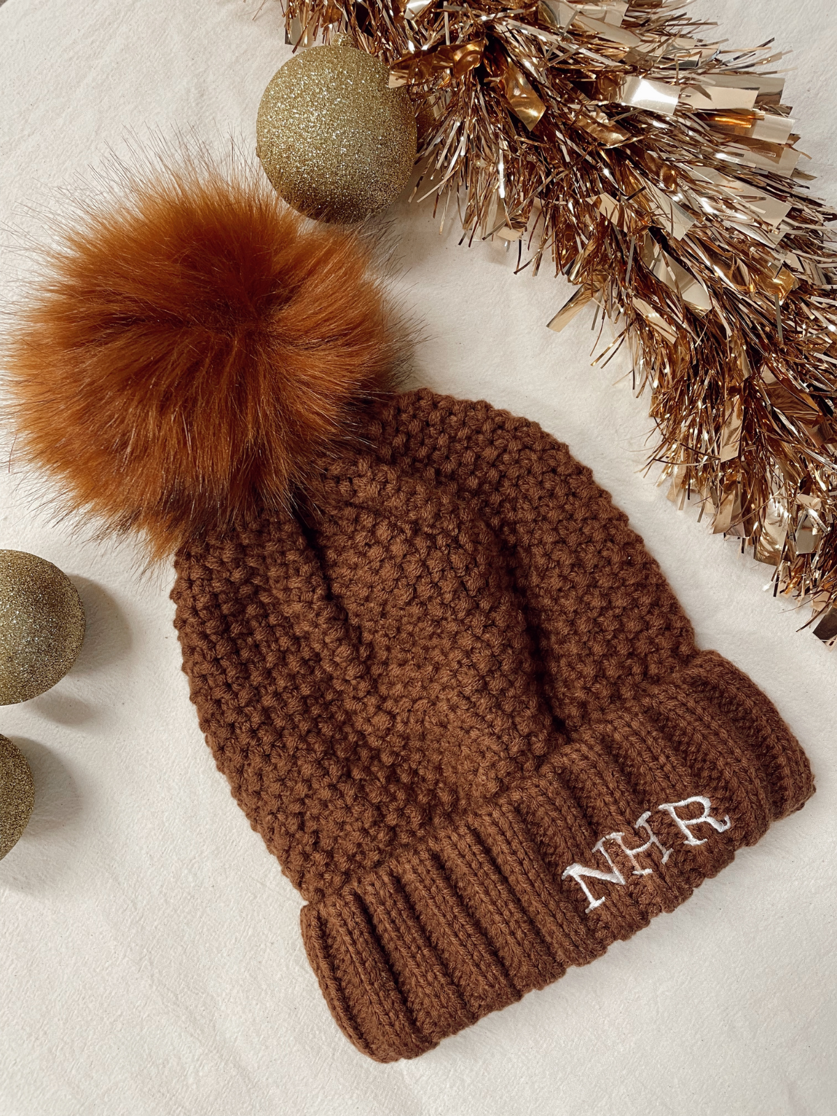 Brown pom pom hat shop